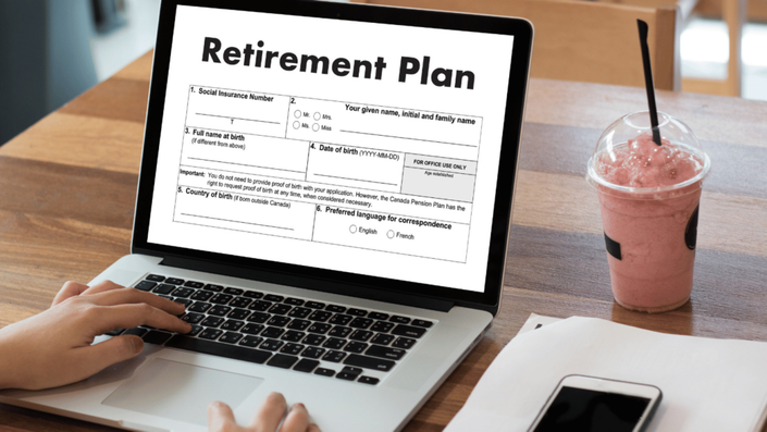 Person reviewing their retirement plan and updating 401(k) contributions on a laptop at a café.
